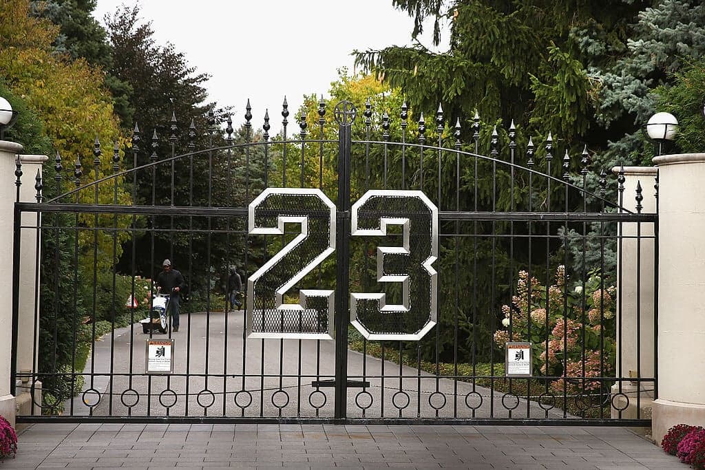 HIGHLAND PARK, IL - OCTOBER 21:  A gate with the number 23 controls access to the home of basketball legend Michael Jordan on October 21, 2013 in Highland Park, Illinois. Twenty-three is the number Jordan wore while playing basketball for the Chicago Bulls. The home which had been offered for sale for $29 million and later dropped to $21 million is scheduled to be sold at auction on November 22. The 32,683-squre-foot home features nine bedrooms, 19 bathrooms, a 15-car attached garage and an "NBA-quality" basketball court.  (Photo by Scott Olson/Getty Images)